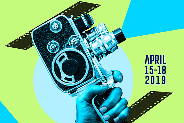 An illustrated blue hand holds a film projector against a lime background. The projector faces the words "April 15-18, 2019"
