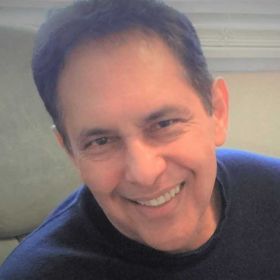 Héctor Calderón smiles in a blurry portrait