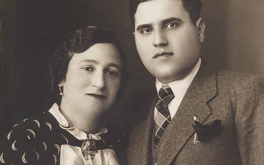 A vintage sepia-toned portrait of a man and woman next to one another