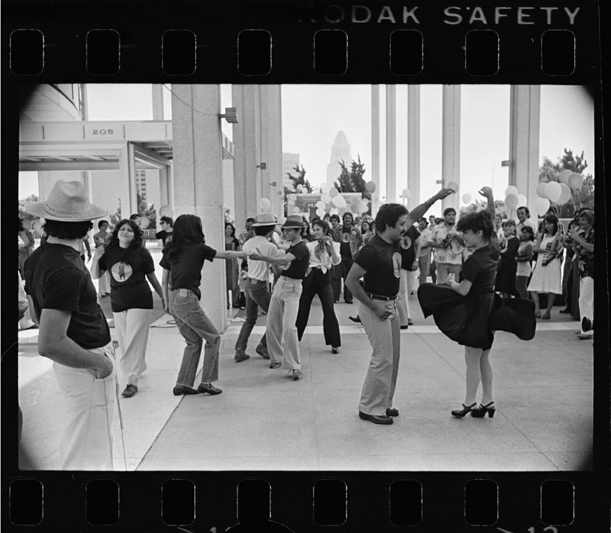 Couples dance in a black-and-white photo