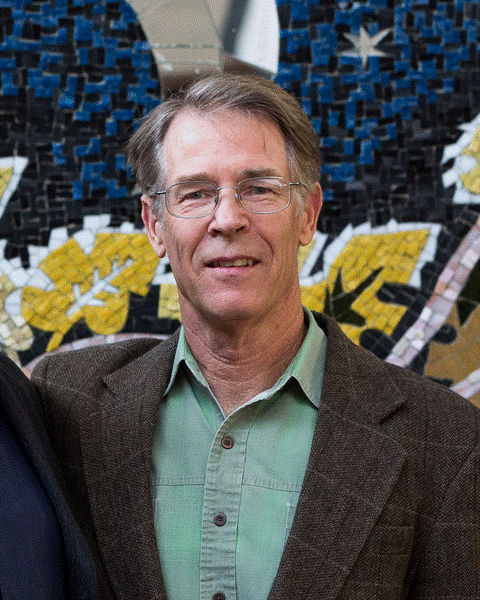 Portrait of Kim Stanley Robinson against a mosaic background.