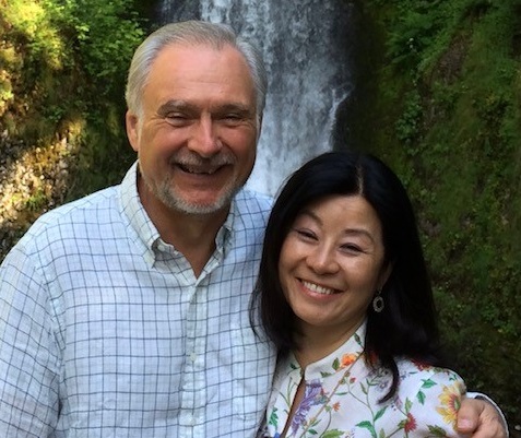 Image of Robert and Christina Buswell in front of a waterfall