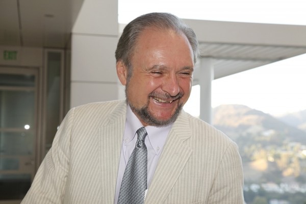 Robert Buswell looks down and laughs with the Getty in the background