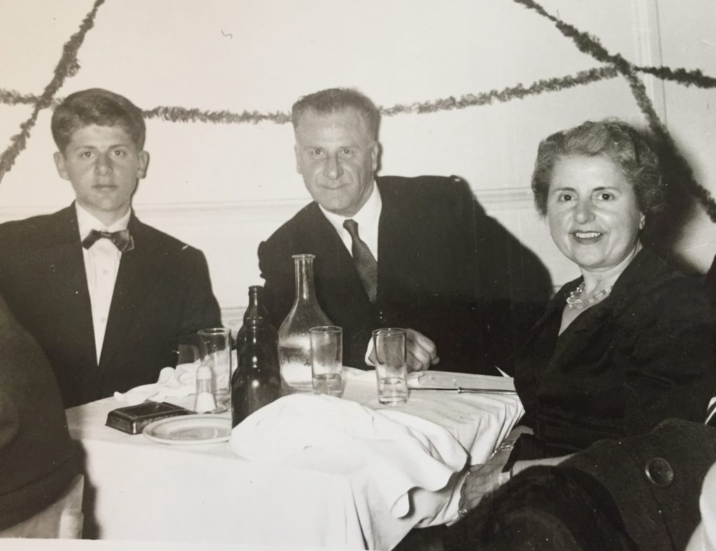 A black and white photo of Peter J. Caloyeras with his parents Ioannis P. and Eirini Caloyeras