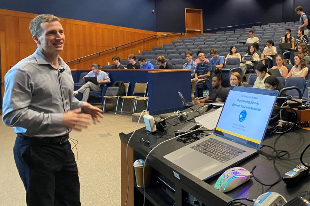 Todd Presner leading a lecture with students in auditorium seats