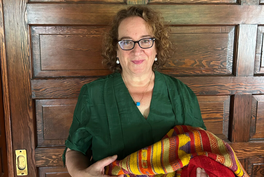 Sharon Gerstel holding a weaving from Geraki, Greece
