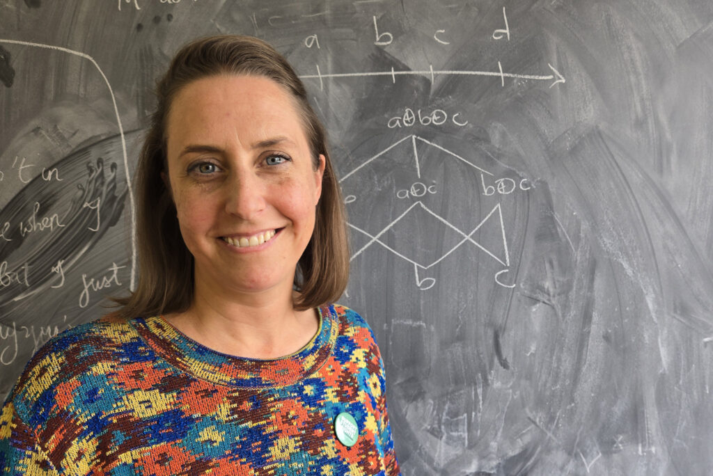 Jessica Rett with chalkboard in background