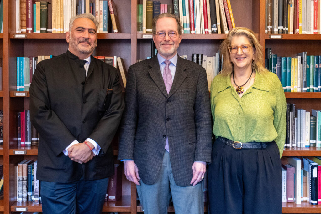 Professor Rahim Shayegan, alumnus Jeffrey Cunard and Dean Alexandra Minna Stern standing in front of large bookshelf.
